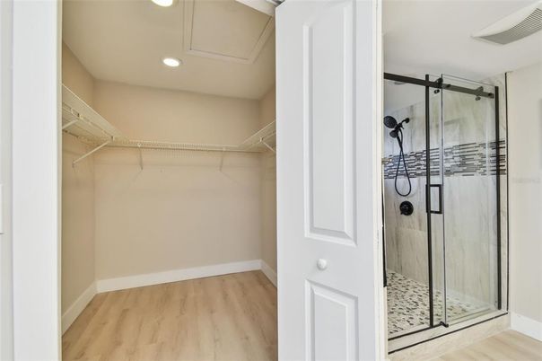 Bathroom, Glass Shower, Interior, Recessed Lighting, Walk-in Closets, Wood Texture Flooring