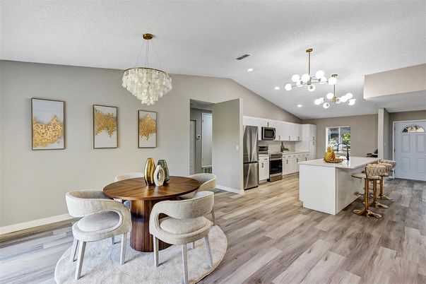 Chandelier, Dining room, Interior, Kitchen, Pendant Lights, Recessed Lighting, Stainless Steel Appliances, Wood Texture Flooring