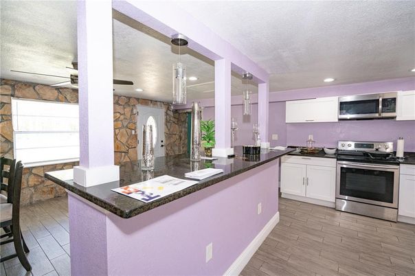 Interior, Kitchen, Pendant Lights, Recessed Lighting, Stainless Steel Appliances, Stone Walls, Wood Texture Flooring