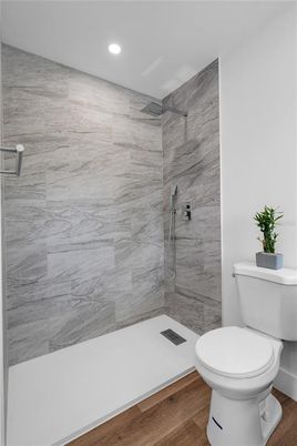 Bathroom, Glass Shower, Interior, Marble Walls, Recessed Lighting, Wood Texture Flooring
