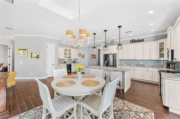 Chandelier, Dining room, Interior, Kitchen, Pendant Lights, Recessed Lighting, Stainless Steel Appliances, Wood Texture Flooring