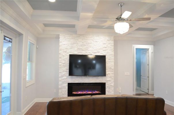 Empty room, Fireplace, Interior, Recessed Lighting, Stone Walls, Wood Texture Flooring