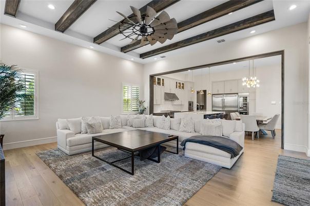 Chandelier, Dining room, Interior, Kitchen, Living room, Pendant Lights, Recessed Lighting, Stainless Steel Appliances, Wooden Beams, Wood Texture Flooring