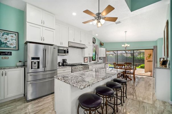 Chandelier, Dining room, Interior, Kitchen, Recessed Lighting, Stainless Steel Appliances, Wood Texture Flooring