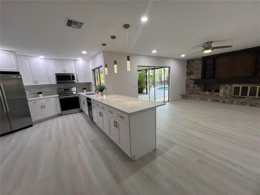 Interior, Kitchen, Pendant Lights, Recessed Lighting, Stainless Steel Appliances, Stone Walls, Wood Texture Flooring