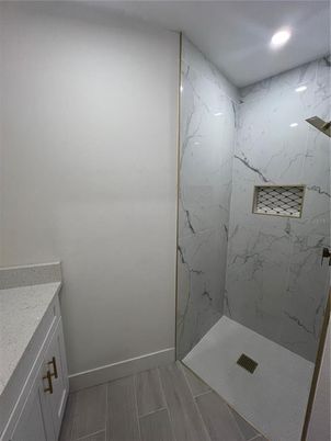Bathroom, Glass Shower, Interior, Marble Walls, Recessed Lighting, Wood Texture Flooring