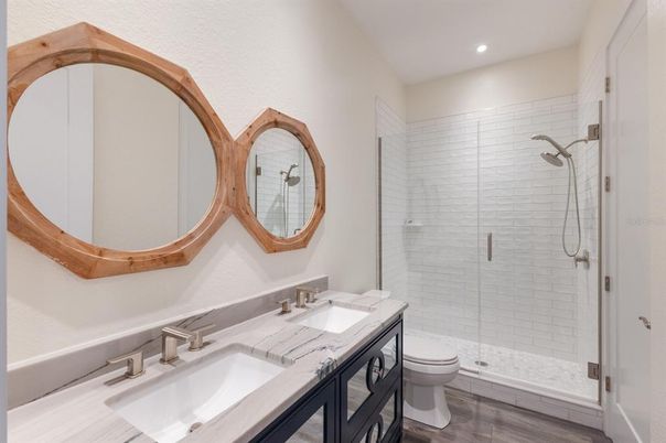 Bathroom, Dual Sink Vanities, Glass Shower, Interior, Recessed Lighting, Wood Texture Flooring