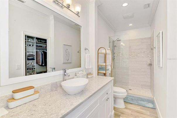 Bathroom, Dual Sink Vanities, Glass Shower, Interior, Recessed Lighting, Walk-in Closets, Wood Texture Flooring