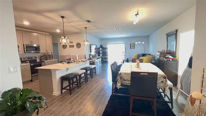 Dining room, Interior, Kitchen, Pendant Lights, Recessed Lighting, Stainless Steel Appliances, Wood Texture Flooring