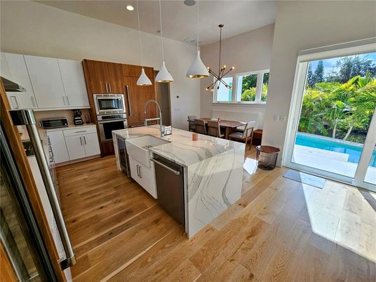 Dining room, Interior, Kitchen, Pendant Lights, Recessed Lighting, Stainless Steel Appliances, Wood Texture Flooring