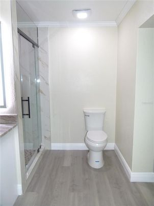 Bathroom, Glass Shower, Interior, Marble Walls, Recessed Lighting, Wood Texture Flooring