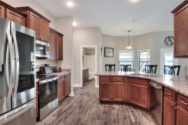 Dining room, Interior, Kitchen, Pendant Lights, Recessed Lighting, Stainless Steel Appliances, Wood Texture Flooring