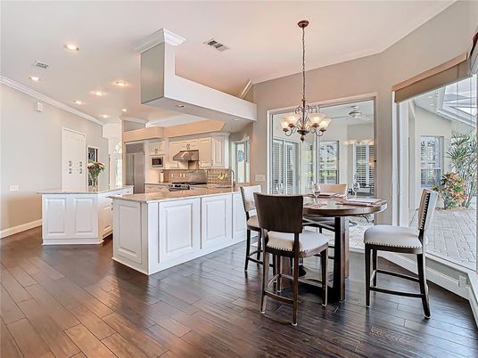 Chandelier, Dining room, Interior, Kitchen, Pendant Lights, Recessed Lighting, Stainless Steel Appliances, Wood Texture Flooring