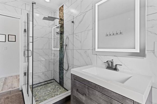 Bathroom, Glass Shower, Interior, Marble Walls, Recessed Lighting, Wood Texture Flooring