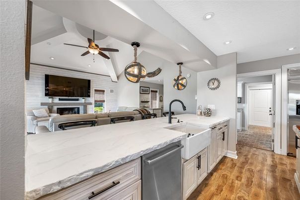 Fireplace, Interior, Kitchen, Living room, Pendant Lights, Recessed Lighting, Stainless Steel Appliances, Wood Texture Flooring