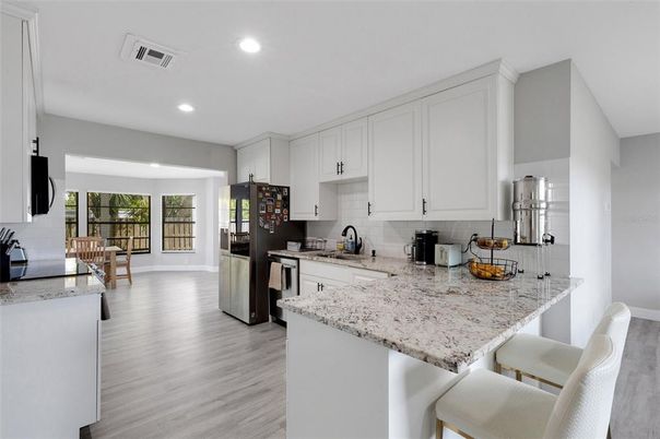 Dining room, Interior, Kitchen, Recessed Lighting, Stainless Steel Appliances, Wood Texture Flooring