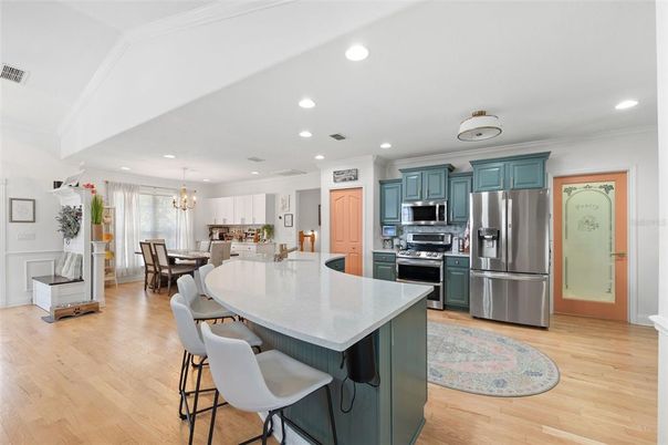 Chandelier, Dining room, Interior, Kitchen, Pendant Lights, Recessed Lighting, Stainless Steel Appliances, Wood Texture Flooring
