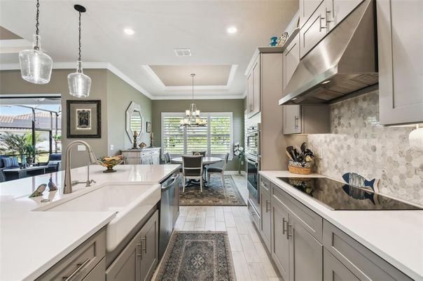 Chandelier, Dining room, Interior, Kitchen, Pendant Lights, Recessed Lighting, Stainless Steel Appliances, Wood Texture Flooring