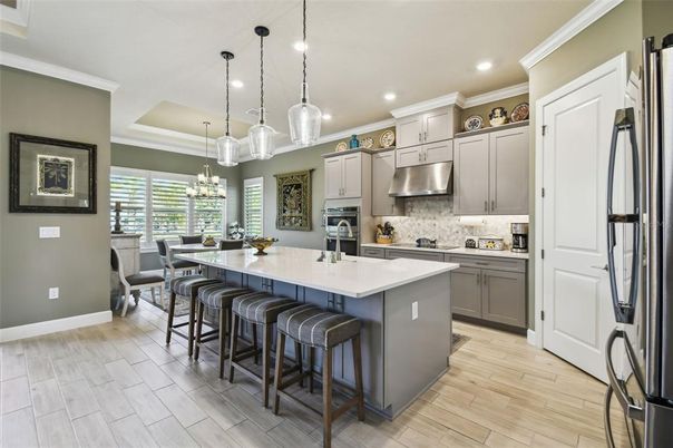 Chandelier, Dining room, Interior, Kitchen, Pendant Lights, Recessed Lighting, Stainless Steel Appliances, Wood Texture Flooring