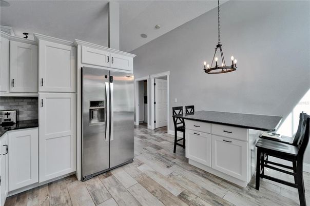 Chandelier, Dining room, Interior, Kitchen, Pendant Lights, Stainless Steel Appliances, Wood Texture Flooring