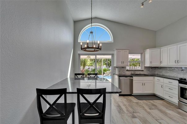 Chandelier, Dining room, Interior, Kitchen, Pendant Lights, Stainless Steel Appliances, Wood Texture Flooring