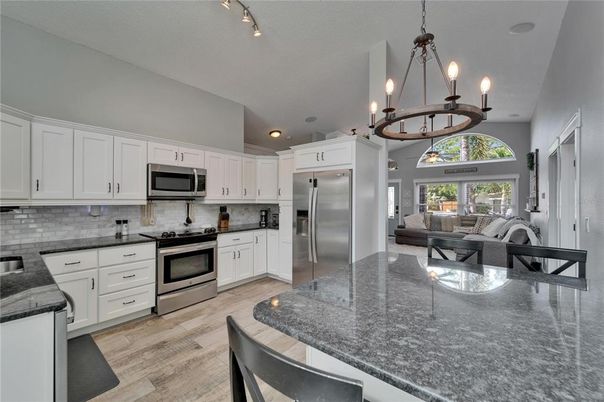 Chandelier, Interior, Kitchen, Living room, Pendant Lights, Recessed Lighting, Stainless Steel Appliances, Wood Texture Flooring
