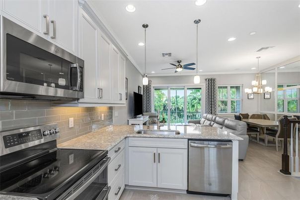 Chandelier, Dining room, Interior, Kitchen, Living room, Pendant Lights, Recessed Lighting, Stainless Steel Appliances