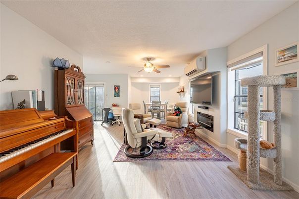 Dining room, Fireplace, Interior, Living room, Piano, Recessed Lighting, Wood Texture Flooring