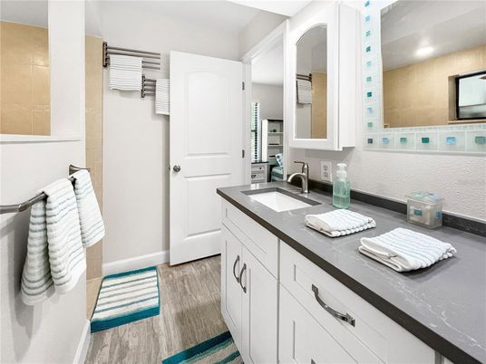 Bathroom, Dual Sink Vanities, Interior, Recessed Lighting, Wood Texture Flooring