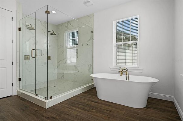 Bathroom, Free Standing Baths, Glass Shower, Interior, Marble Walls, Recessed Lighting, Wood Texture Flooring