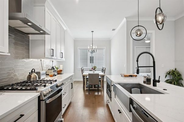 Chandelier, Dining room, Interior, Kitchen, Pendant Lights, Stainless Steel Appliances, Wood Texture Flooring