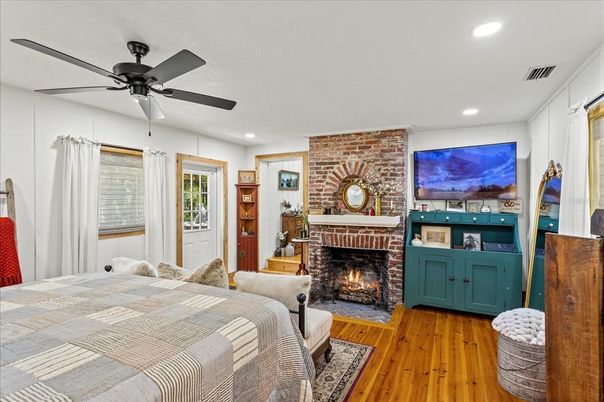 Bedroom, Fireplace, Interior, Recessed Lighting, Stone Walls, Wood Texture Flooring