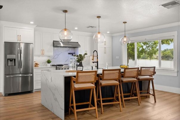 Interior, Kitchen, Marble Walls, Pendant Lights, Recessed Lighting, Stainless Steel Appliances, Wood Texture Flooring
