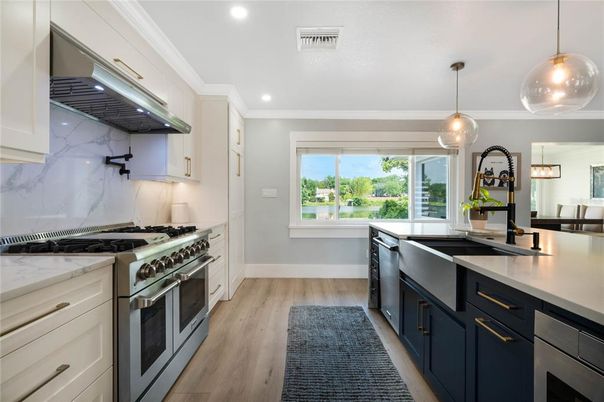Interior, Kitchen, Marble Walls, Pendant Lights, Recessed Lighting, Stainless Steel Appliances, Wood Texture Flooring