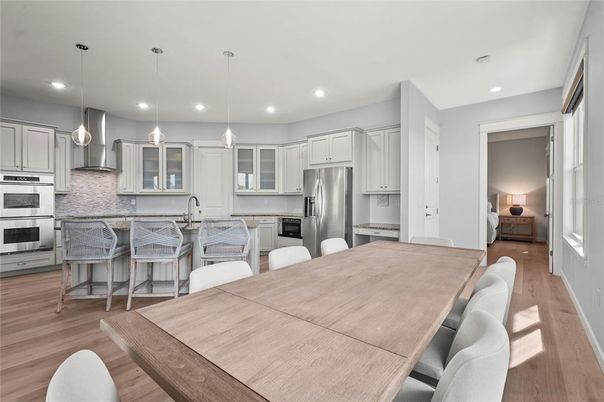 Dining room, Interior, Kitchen, Pendant Lights, Recessed Lighting, Stainless Steel Appliances, Wood Texture Flooring