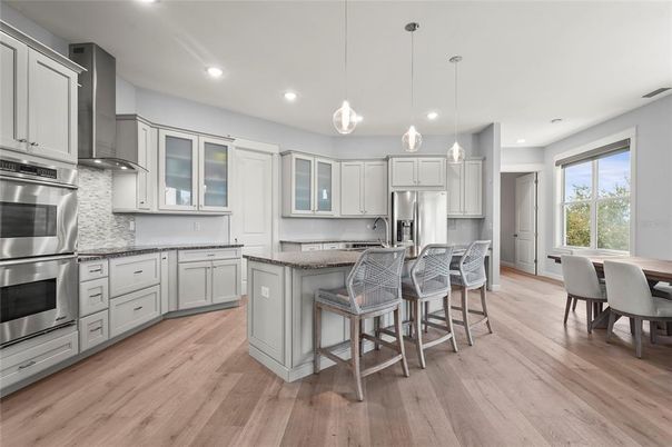 Dining room, Interior, Kitchen, Pendant Lights, Recessed Lighting, Stainless Steel Appliances, Wood Texture Flooring