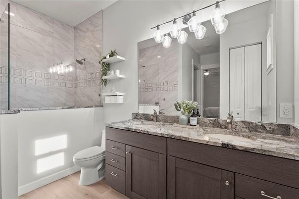 Bathroom, Dual Sink Vanities, Glass Shower, Interior, Marble Walls, Wood Texture Flooring