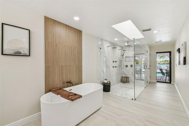 Bathroom, Free Standing Baths, Glass Shower, Interior, Marble Walls, Recessed Lighting, Wood Texture Flooring