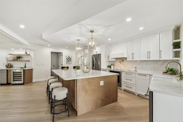 Interior, Kitchen, Marble Walls, Pendant Lights, Recessed Lighting, Stainless Steel Appliances, Wood Texture Flooring