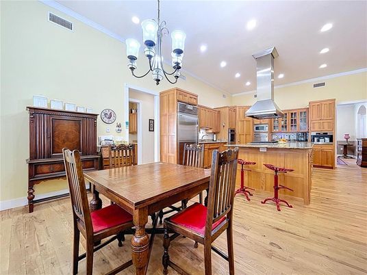 Chandelier, Dining room, Interior, Kitchen, Recessed Lighting, Stainless Steel Appliances, Wood Texture Flooring