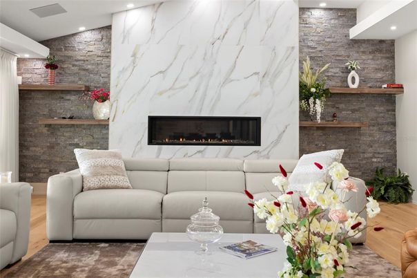 Fireplace, Interior, Living room, Marble Walls, Recessed Lighting, Stone Walls, Wood Texture Flooring