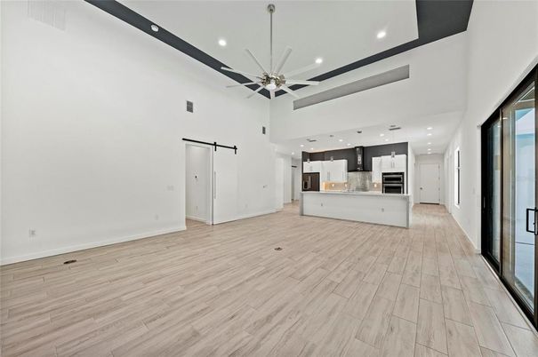 Empty room, Interior, Kitchen, Pendant Lights, Recessed Lighting, Stainless Steel Appliances, Wood Texture Flooring