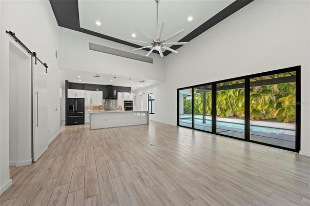 Empty room, Interior, Kitchen, Recessed Lighting, Stainless Steel Appliances, Wood Texture Flooring