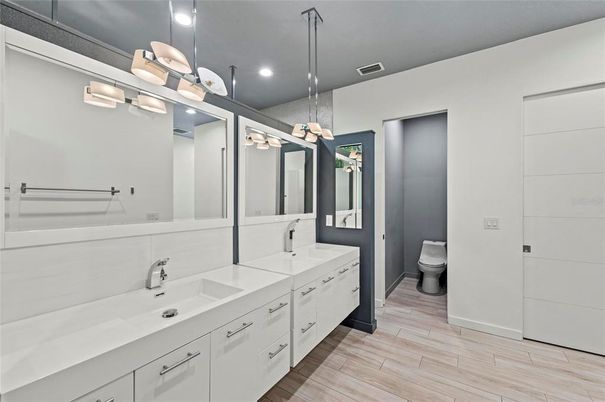 Bathroom, Dual Sink Vanities, Interior, Pendant Lights, Recessed Lighting, Wood Texture Flooring