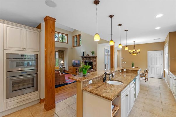Chandelier, Dining room, Fireplace, Interior, Kitchen, Living room, Pendant Lights, Recessed Lighting, Wood Texture Flooring