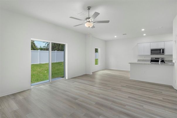Empty room, Interior, Kitchen, Recessed Lighting, Stainless Steel Appliances, Wood Texture Flooring