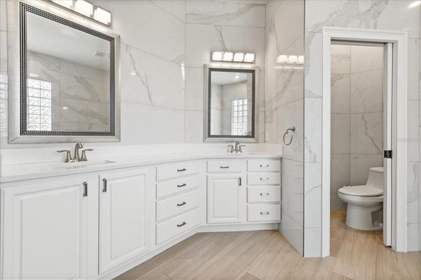 Bathroom, Dual Sink Vanities, Interior, Marble Walls, Wood Texture Flooring