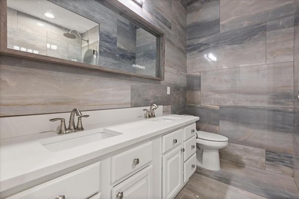 Bathroom, Dual Sink Vanities, Glass Shower, Interior, Recessed Lighting, Wood Texture Flooring