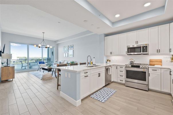 Chandelier, Dining room, Interior, Kitchen, Pendant Lights, Recessed Lighting, Stainless Steel Appliances, Wood Texture Flooring