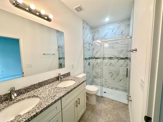 Bathroom, Dual Sink Vanities, Glass Shower, Interior, Marble Walls, Recessed Lighting